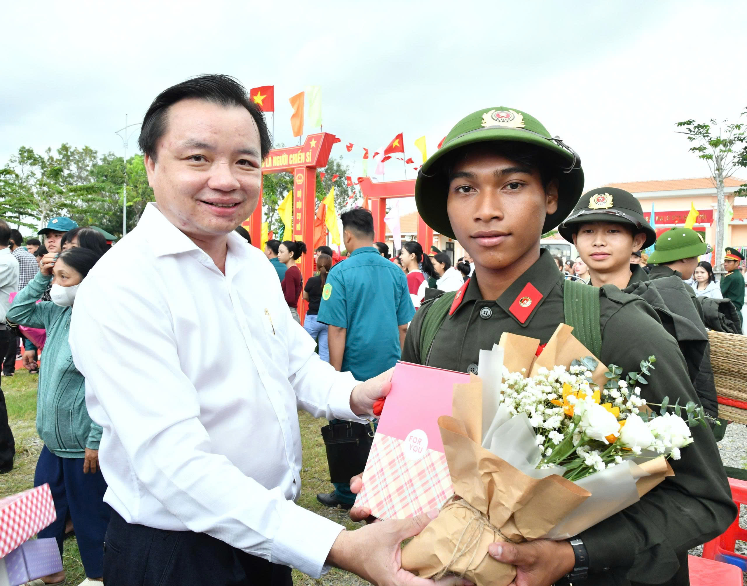 Ảnh 4: Đồng chí Dương Minh Tâm - Bí thư Đảng uỷ xã Hòn Đất tặng quà và hoa cho tân binh lên đường nhập ngũ năm 2026
